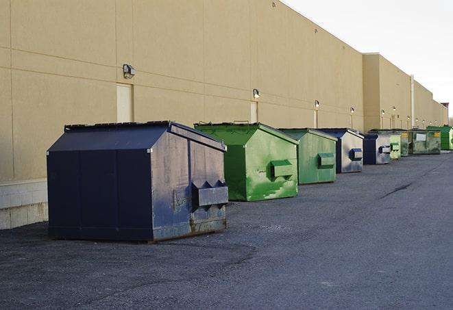 a red construction dumpster placed in front of a building under construction in Huntley, IL